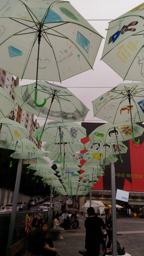 By children, drawings on umbrellas.
