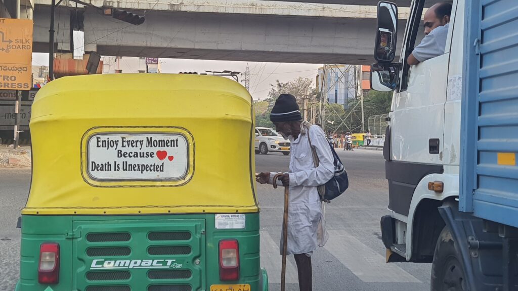 Auto with the board " Enjoy every moment because death is unexpected"