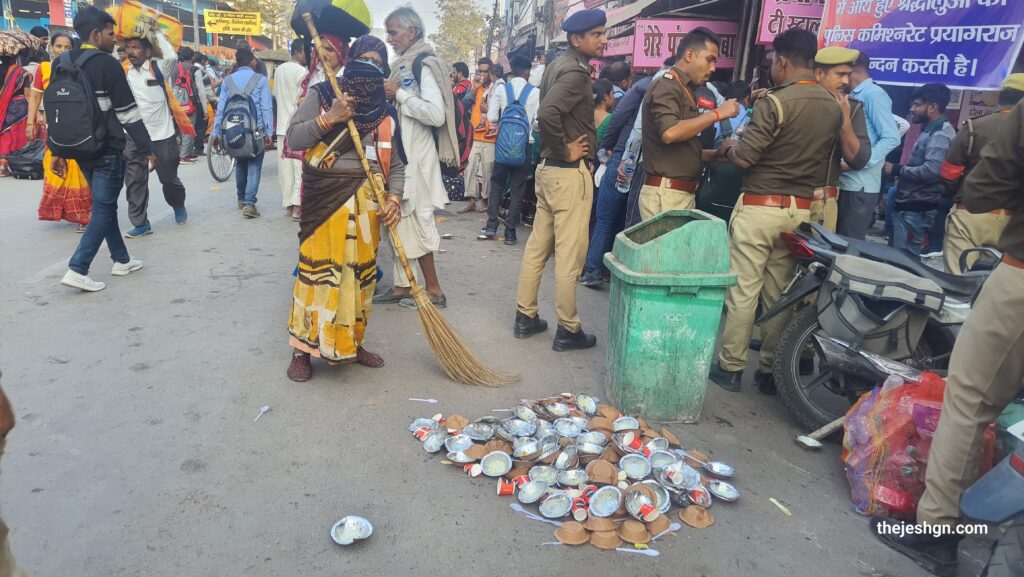 Worker cleaning the cups thrown by people